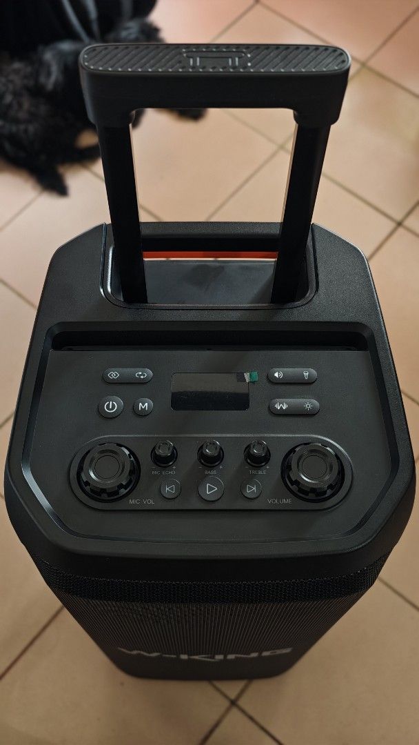 W-King T12 (Category: Soundbars, Speakers & Amplifiers) located in Caloocan City. Submitted by baddaks (Listing ID 1464958427, Image 3). Description: W-King T12 trolley party speaker. Dual front woofers with built-in LED lighting rings. Top control panel includes dedicated knobs for volume, mic volume, bass, and treble. Rear panel features multiple audio ports, power supply module, and dual wheels with an extendable handle for easy transport. UNI