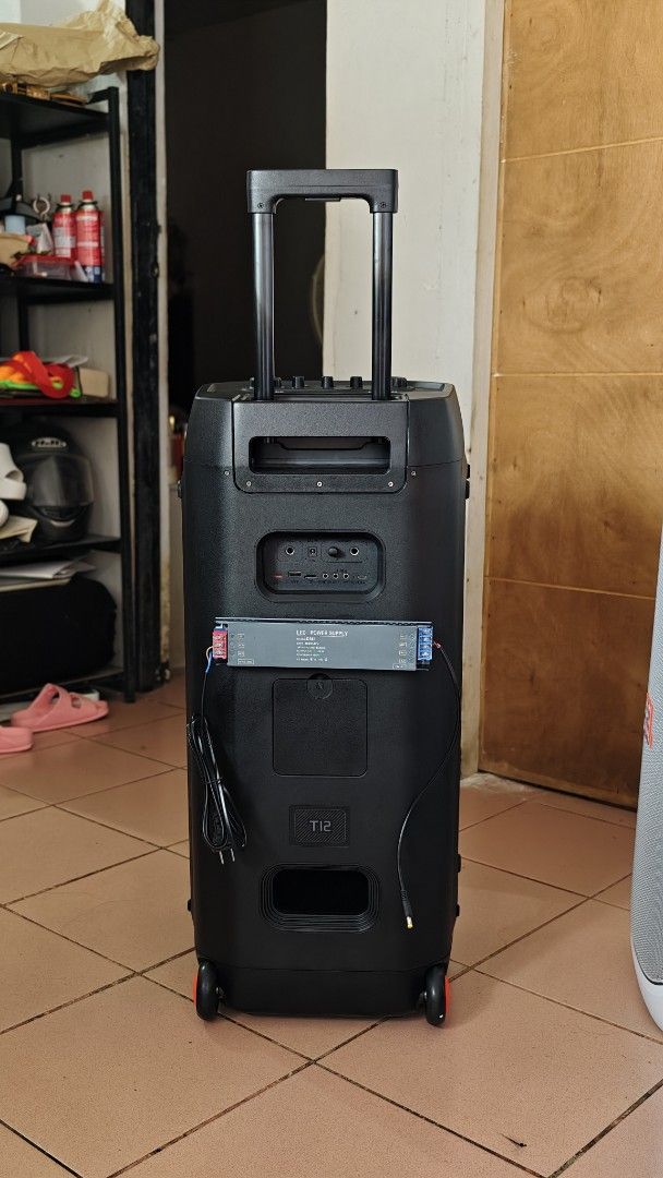 W-King T12 (Category: Soundbars, Speakers & Amplifiers) located in Caloocan City. Submitted by baddaks (Listing ID 1464958427, Image 2). Description: W-King T12 trolley party speaker. Dual front woofers with built-in LED lighting rings. Top control panel includes dedicated knobs for volume, mic volume, bass, and treble. Rear panel features multiple audio ports, power supply module, and dual wheels with an extendable handle for easy transport. UNI