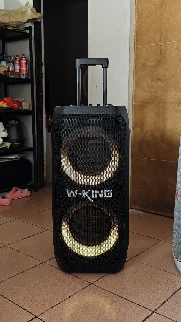 W-King T12 (Category: Soundbars, Speakers & Amplifiers) located in Caloocan City. Submitted by baddaks (Listing ID 1464958427, Image 1). Description: W-King T12 trolley party speaker. Dual front woofers with built-in LED lighting rings. Top control panel includes dedicated knobs for volume, mic volume, bass, and treble. Rear panel features multiple audio ports, power supply module, and dual wheels with an extendable handle for easy transport. UNI