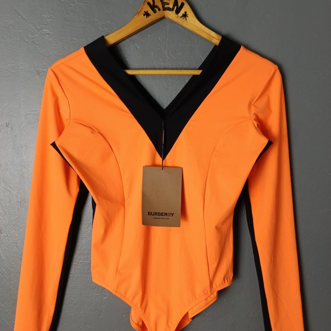 Women's - Burberry (Category: Activewear) located in Bacolod City. Submitted by drop.ph (Listing ID 1464878748, Image 1). Description: Burberry - Bright Orange Body Suit *Size M - 16.5x17.5 *Brand New w Tags *Minor ink stain at the back *Price: 2,500php *Add SF if outside Bacolod City.