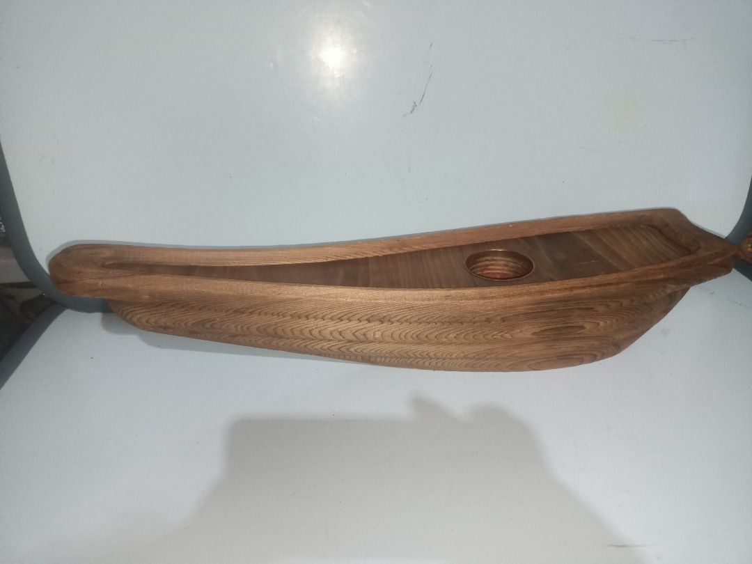 Wooden Boat Shaped Ikebana (Category: Vases & Decorative Bowls) located in Munoz. Submitted by larryc1212 (Listing ID 1464895398, Image 1). Description: - Handcrafted wooden sculpture shaped like a traditional boat - Measures approximately 19 inches in length - Built-in metal cup holder in the center, ideal for flowers - Beautiful natural wood grain texture visible throughout - Sturdy construction with a flat base for stable placement on tables o