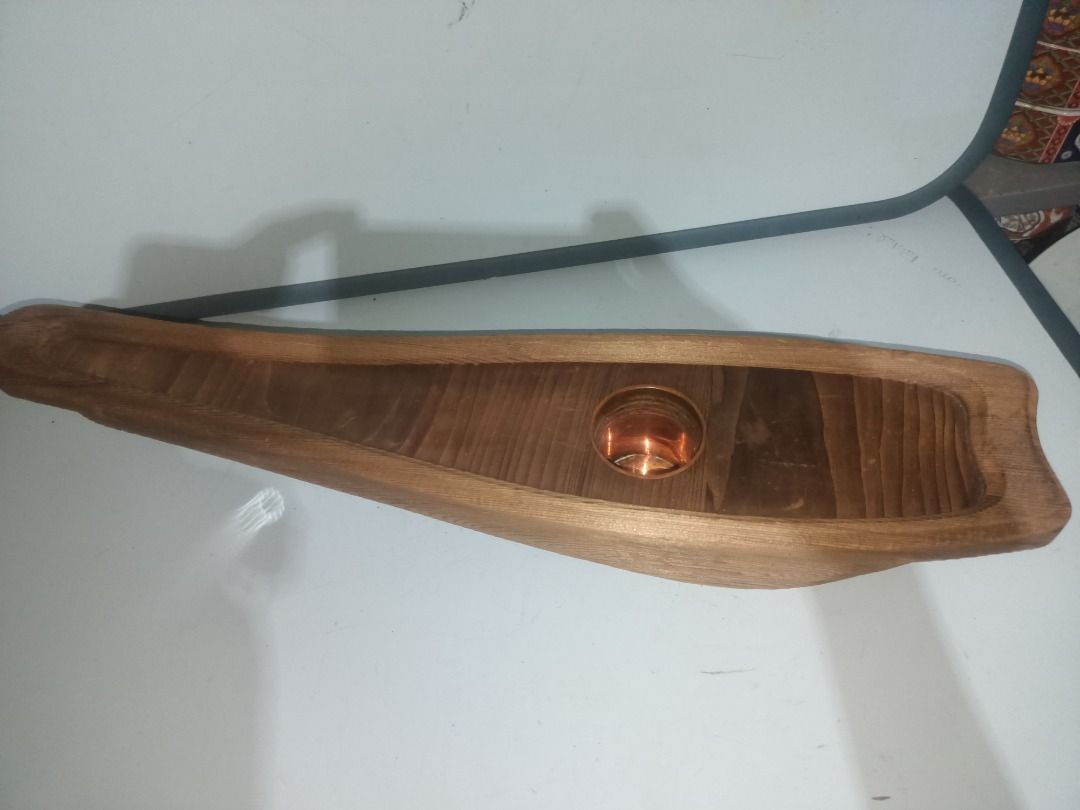 Wooden Boat Shaped Ikebana (Category: Vases & Decorative Bowls) located in Munoz. Submitted by larryc1212 (Listing ID 1464895398, Image 2). Description: - Handcrafted wooden sculpture shaped like a traditional boat - Measures approximately 19 inches in length - Built-in metal cup holder in the center, ideal for flowers - Beautiful natural wood grain texture visible throughout - Sturdy construction with a flat base for stable placement on tables o