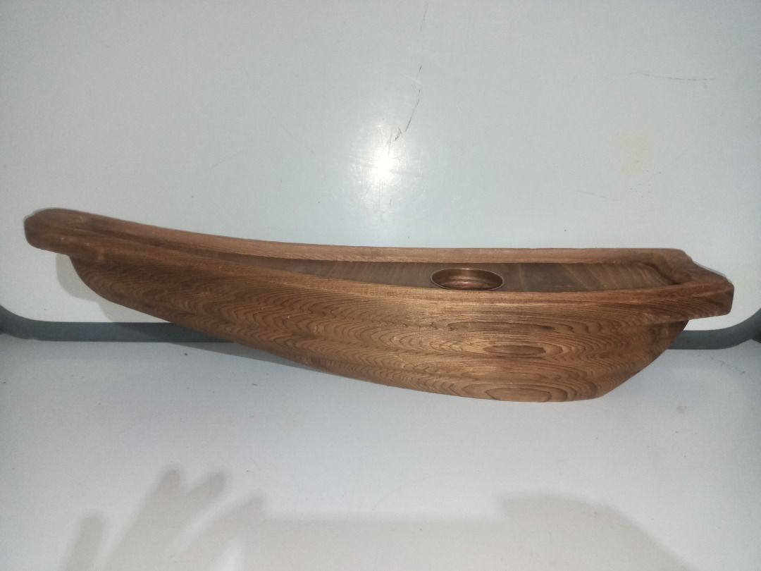 Wooden Boat Shaped Ikebana (Category: Vases & Decorative Bowls) located in Munoz. Submitted by larryc1212 (Listing ID 1464895398, Image 3). Description: - Handcrafted wooden sculpture shaped like a traditional boat - Measures approximately 19 inches in length - Built-in metal cup holder in the center, ideal for flowers - Beautiful natural wood grain texture visible throughout - Sturdy construction with a flat base for stable placement on tables o