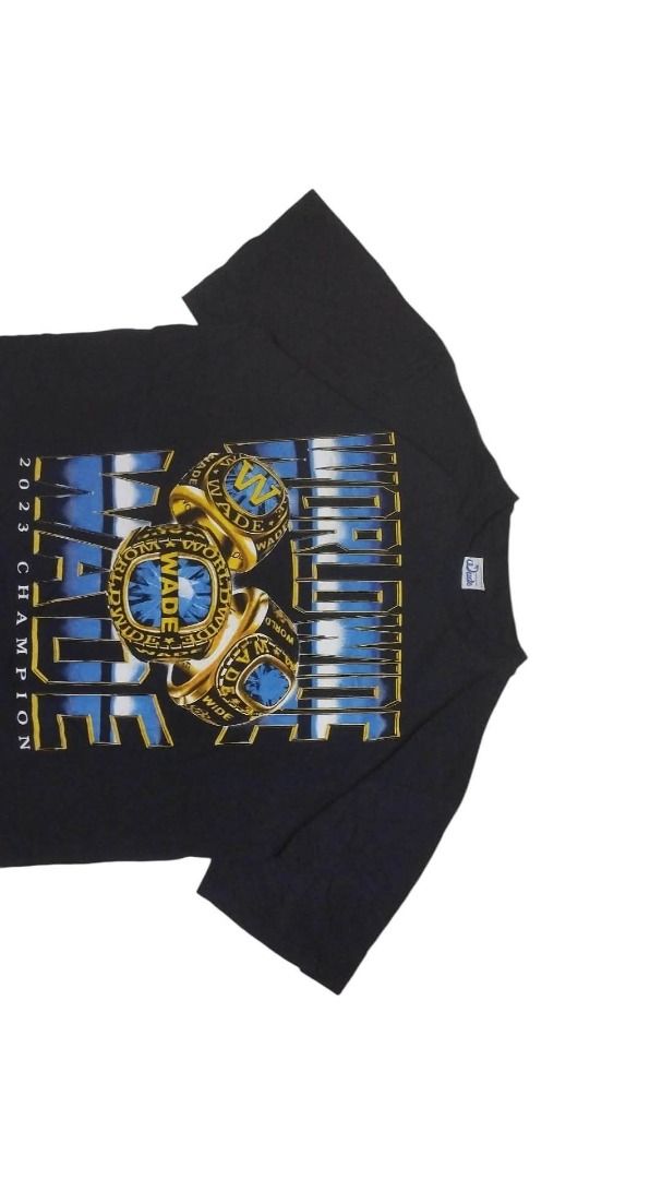 WORLDWIDE WADE RINGER TEE (Category: Tshirts & Polo Shirts ) located in Koronadal. Submitted by theminance (Listing ID 1464775418, Image 3). Description: -22.5X28 ( LARGE ) - Color: Black - Design: Large front graphic featuring 'WORLDWIDE WADE', three championship rings in blue and gold tones, and '2023 CHAMPION' text at the bottom - Fit: Standard fit / Regular cotton tee style - Neckline: Crew neck - Sleeves: Short sleeves - Condition: Brand new
