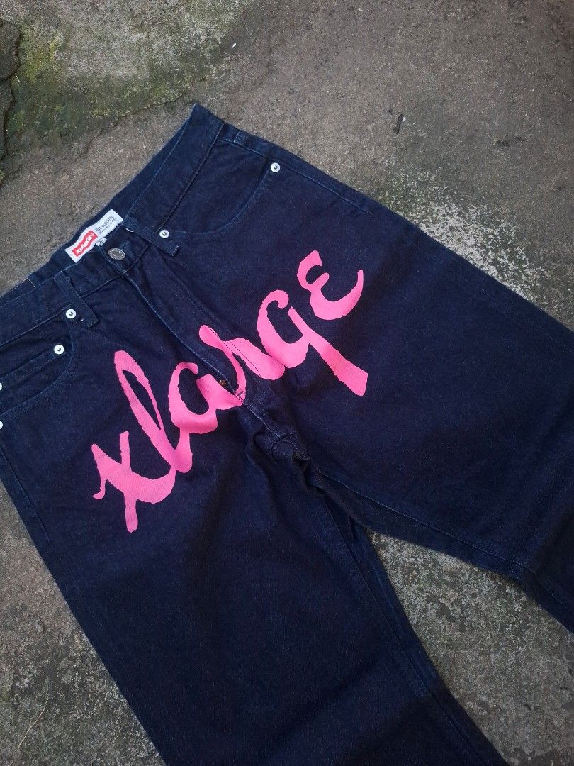Xlarge Front Script Denim Pants Selvedge - Size 30 (Category: Jeans) located in Manila. Submitted by bonaobrag55538 (Listing ID 1464845094, Image 3). Description: - Brand: Xlarge - Style: Dark wash selvedge denim pants - Dimes: 30*42*8 - Details: Bold pink script logo on front, classic cuff detail, and back leather patch - Condition: Excellent, clean inside and out with zero flaws and preserved dark indigo color - Material: Heavyweight denim with