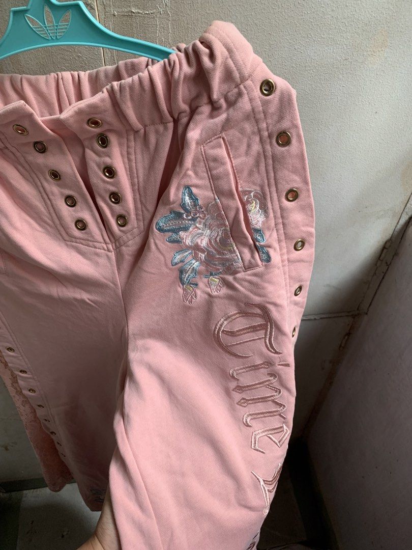 Y2k sweat pants (Category: Jeans) located in Manila. Submitted by usagichan_rabbit (Listing ID 1464842445, Image 2). Description: - Pink streetwear sweatpants with a comfy relaxed fit and elastic waistband - Gorgeous floral embroidery near the hip and hem - Edgy chunky metal eyelet details on the front placket and outer seams - Features a delicate pink lace panel on one side - Perfect for a stylish and cozy casual look 27-29 waistline.