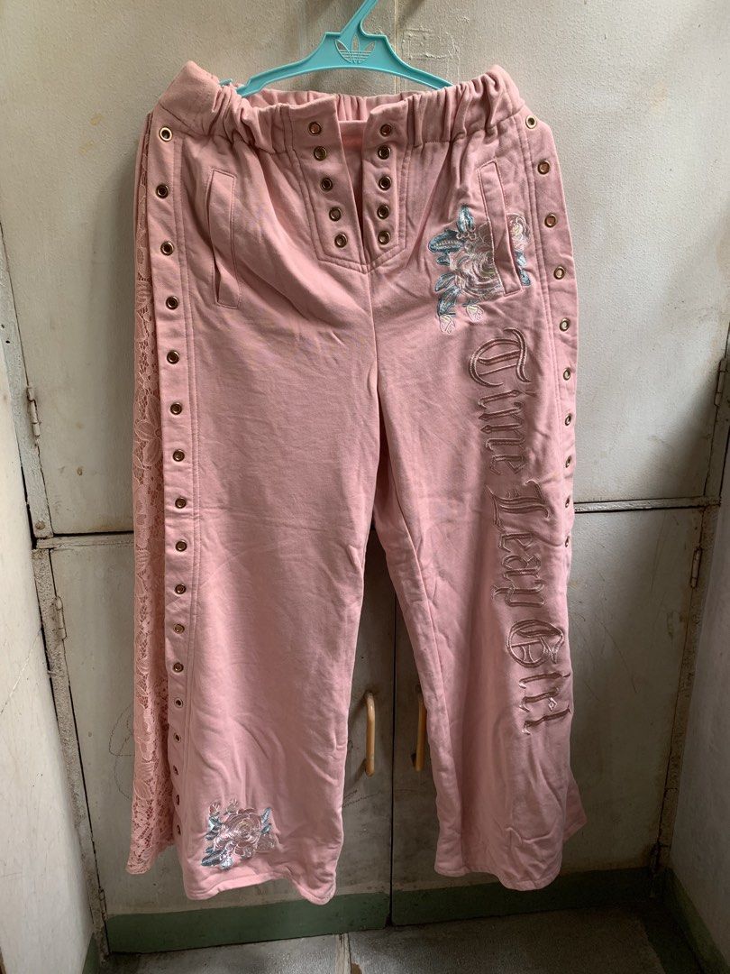 Y2k sweat pants (Category: Jeans) located in Manila. Submitted by usagichan_rabbit (Listing ID 1464842445, Image 1). Description: - Pink streetwear sweatpants with a comfy relaxed fit and elastic waistband - Gorgeous floral embroidery near the hip and hem - Edgy chunky metal eyelet details on the front placket and outer seams - Features a delicate pink lace panel on one side - Perfect for a stylish and cozy casual look 27-29 waistline.