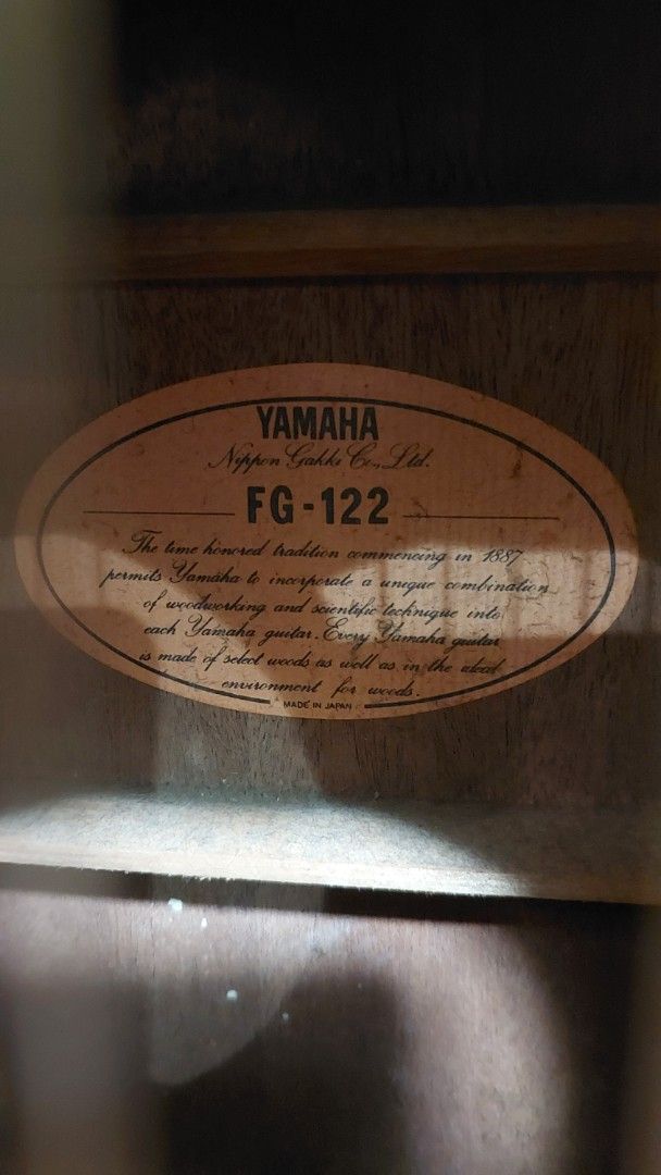 Yamaha FG-122 Acoustic Guitar (Category: Musical Instruments) located in Baliuag. Submitted by papa.gardz (Listing ID 1464904566, Image 2). Description: - Vintage Yamaha FG-122 acoustic guitar from the iconic Nippon Gakki era (Made in Japan) - Beautiful rosewood back and sides with warm grain patterns - Condition: Shows visible surface scratches and minor wear consistent with age and regular playing.