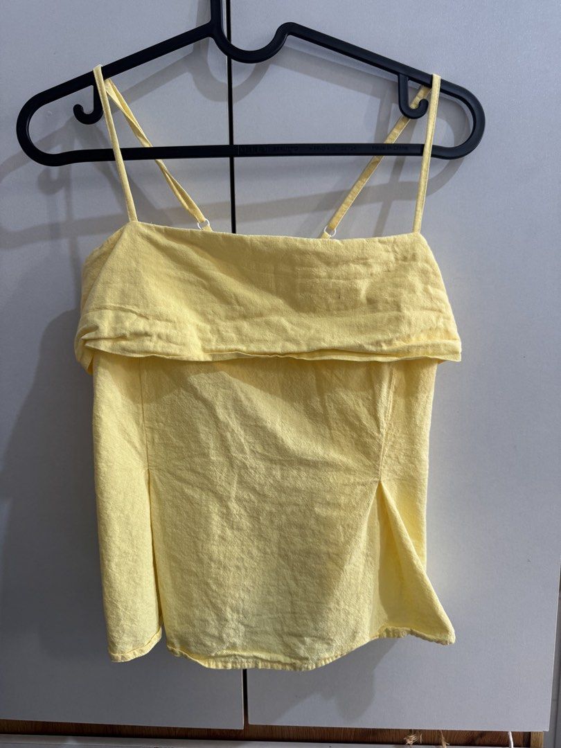 Yellow Cami Top with Flap Overlay and Smocked Back (Category: Sleeveless) located in Manila. Submitted by d.clutterrr (Listing ID 1464784592, Image 1). Description: - Color: Bright yellow - Design: Layered flap across the chest with a flared hem - Fit: Adjustable spaghetti straps and a stretchy smocked back panel - Fabric: Lightweight and breathable, perfect for warm weather - Condition: 8/10 (Need lang planstahin) .