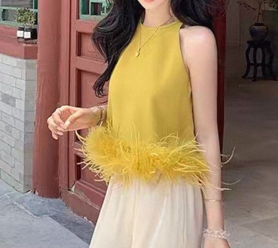 Yellow Feather Hem Halter Tank Top (Category: Sleeveless) located in Marikina City. Submitted by lovegoeson (Listing ID 1464890872, Image 3). Description: - Color: Bright yellow - Style: Halter neck, sleeveless - Feature: Textured feather trim along the hem - feather hem detachable - Perfect for: Summer outfits, pairing with high-waisted pants or skirts.