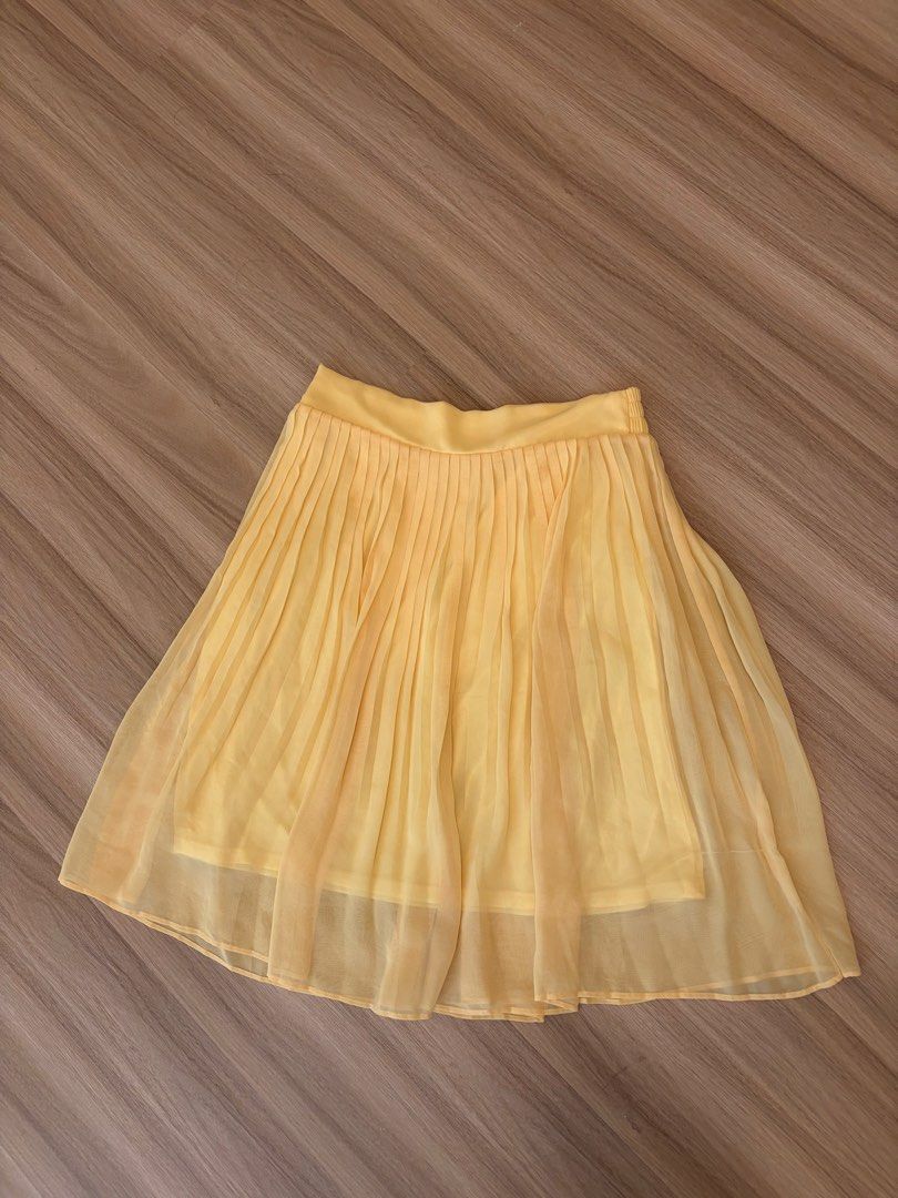Yellow Pleated Chiffon Skirt (Category: Skirts) located in Manila. Submitted by ele.ele (Listing ID 1464804266, Image 1). Description: - Bright yellow pleated chiffon skirt - Comfy elastic waistband for an easy fit - Lightweight, layered fabric with a nice flow - Perfect staple piece to pair with basic tees or blouses - Ideal for sunny days - Fits small - Minor stain on upper left side but barely noticeable (highlighted in photo).