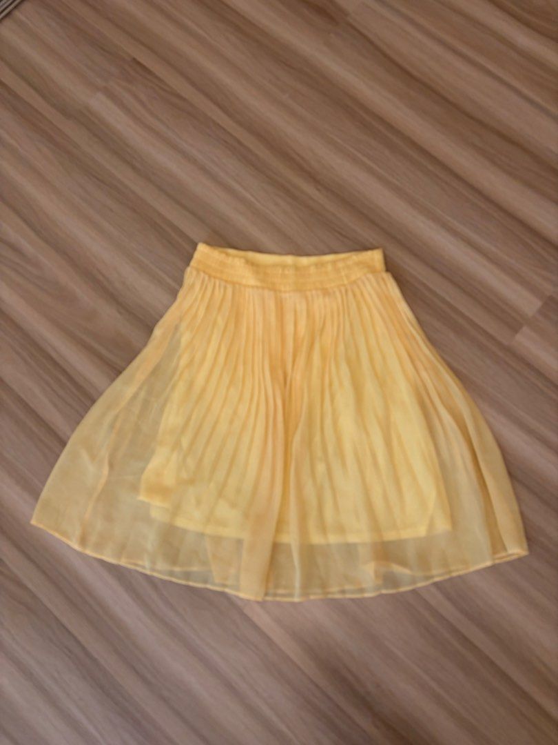Yellow Pleated Chiffon Skirt (Category: Skirts) located in Manila. Submitted by ele.ele (Listing ID 1464804266, Image 2). Description: - Bright yellow pleated chiffon skirt - Comfy elastic waistband for an easy fit - Lightweight, layered fabric with a nice flow - Perfect staple piece to pair with basic tees or blouses - Ideal for sunny days - Fits small - Minor stain on upper left side but barely noticeable (highlighted in photo).
