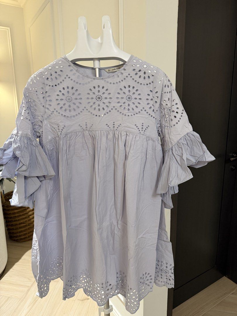 Zara Basic Blue Eyelet Embroidery Ruffle Sleeve Tunic Blouse (Category: Blouses) located in Makati City. Submitted by 1st_Dibs (Listing ID 1464892988, Image 3). Description: - Brand: Zara Basic - Color: Light blue -Length: 35 inches - Size: EUR L, USA L, MEX 30 - Material/Origin: Made in India - Details: Intricate eyelet embroidery on chest and hem - Sleeves: Layered ruffle sleeves for a relaxed, flowy fit - Neckline: Round neck with back button 