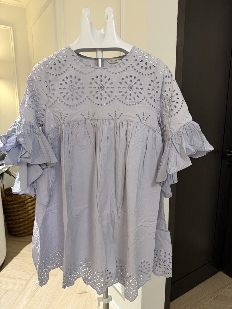 Zara Basic Blue Eyelet Embroidery Ruffle Sleeve Tunic Blouse (Category: Blouses) located in Makati City. Submitted by 1st_Dibs (Listing ID 1464892988, Image 2). Description: - Brand: Zara Basic - Color: Light blue -Length: 35 inches - Size: EUR L, USA L, MEX 30 - Material/Origin: Made in India - Details: Intricate eyelet embroidery on chest and hem - Sleeves: Layered ruffle sleeves for a relaxed, flowy fit - Neckline: Round neck with back button 