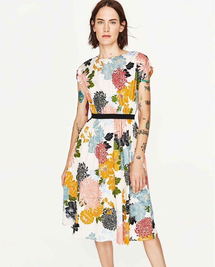 Zara Basic Floral Print Midi Dress (Category: Dresses) located in Makati City. Submitted by 1st_Dibs (Listing ID 1464890487, Image 1). Description: - Brand/Collection: Zara Basic -Length: 41 inches - Style: Floral midi dress with contrasting black waistband - Color: Cream base with orange, yellow, blue, and black floral print - Details: Cap sleeves, round neckline - Size: L - Material: Lightweight fabric - Origin: Made in Spain - Condition: Great