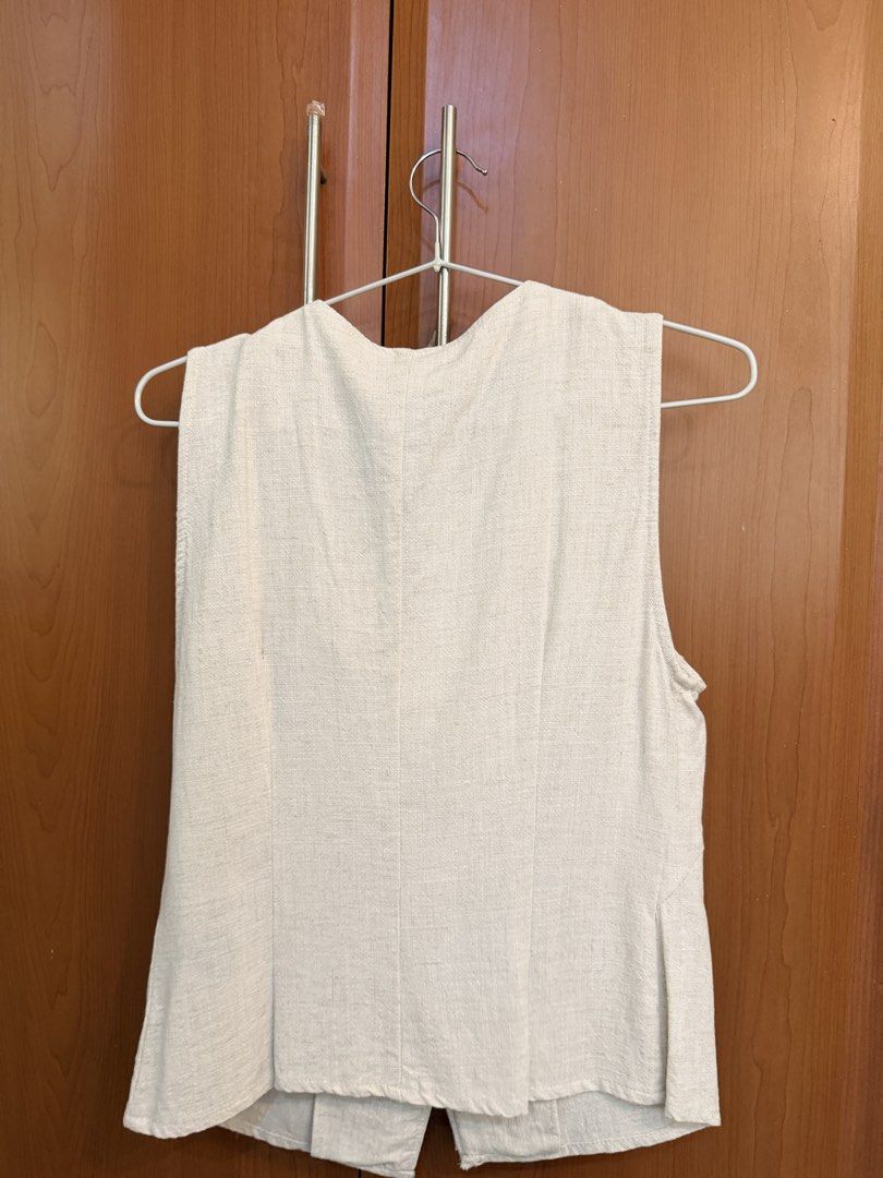 Zara Beige Asymmetric Button Vest Top Size M (Category: Sleeveless) located in Quezon City. Submitted by savjel08 (Listing ID 1464777789, Image 2). Description: - Brand: Zara - Color: Beige - Size: M - Origin: Made in Morocco - Design: Asymmetric front with 3 matching buttons - Material: Textured linen-look fabric with clean panel seams - Style: Sleeveless, collarless neckline - Versatility: Great for layering over shirts or wearing solo.