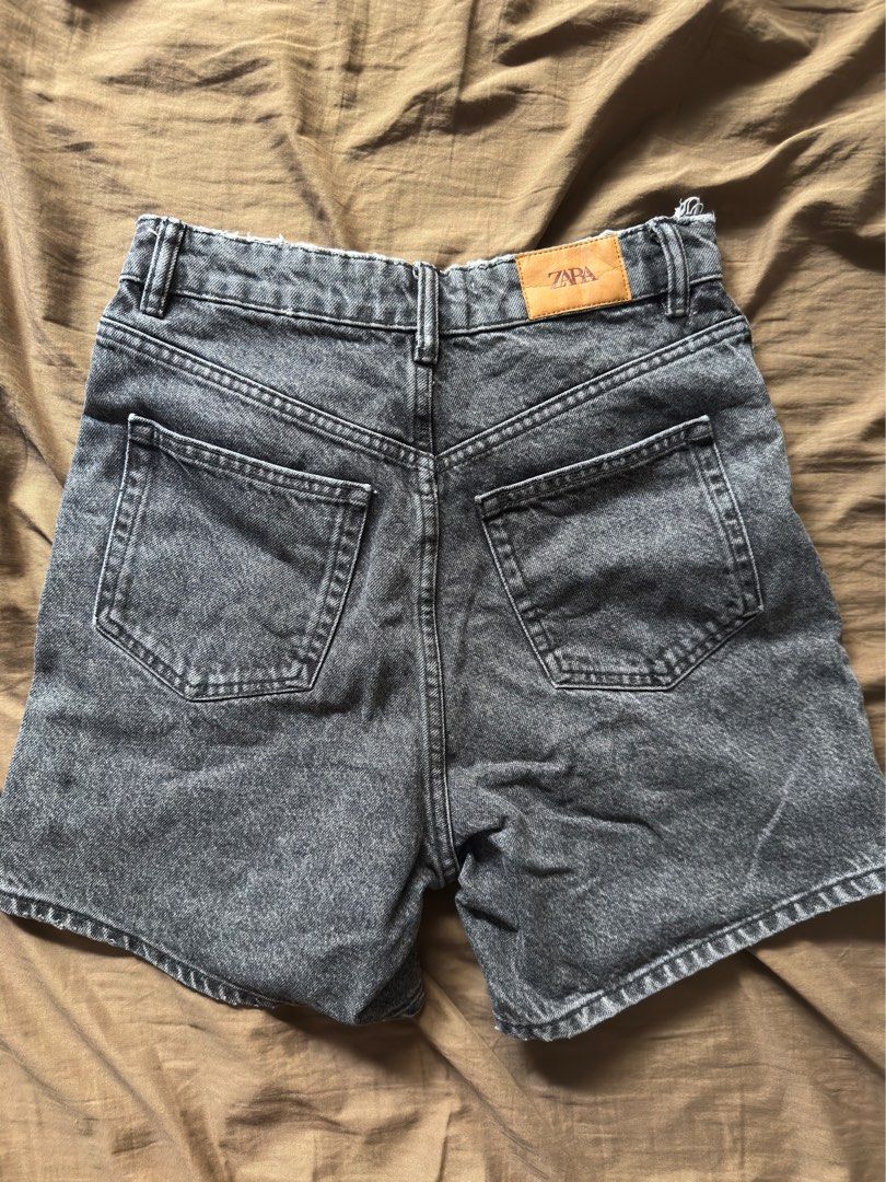 Zara Grey Denim Shorts (Category: Shorts) located in Nasipit. Submitted by pyanstar (Listing ID 1464804831, Image 2). Description: - Brand: Zara TRF Collection - Style: Washed grey denim shorts with a heavily faded finish - Details: Classic five-pocket design, button fly with branded hardware, leather-look patch on back waistband - Hem: Trendy frayed raw hem - Origin: Made in Bangladesh - Condition: Excellent pre-loved/brand new (as applicable) -