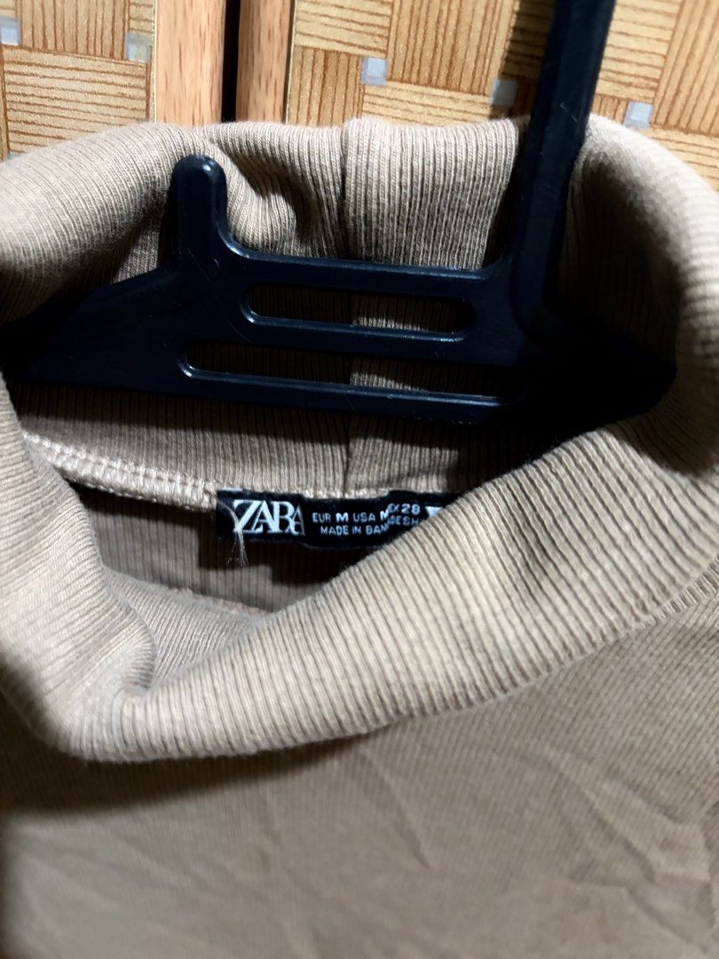 Zara Ribbed Turtleneck Top Medium Brown (Category: Longsleeves) located in Pangil. Submitted by chel_anne (Listing ID 1464836609, Image 3). Description: - Brand: Zara - Style: Ribbed turtleneck with half sleeves - Size: S EUR 36 - Color: Brown (Neutral, great for layering) - Fit: Stretchy and comfortable - Origin: Made in Bangladesh - Pairing: Easy to style with high-waisted jeans or skirts.