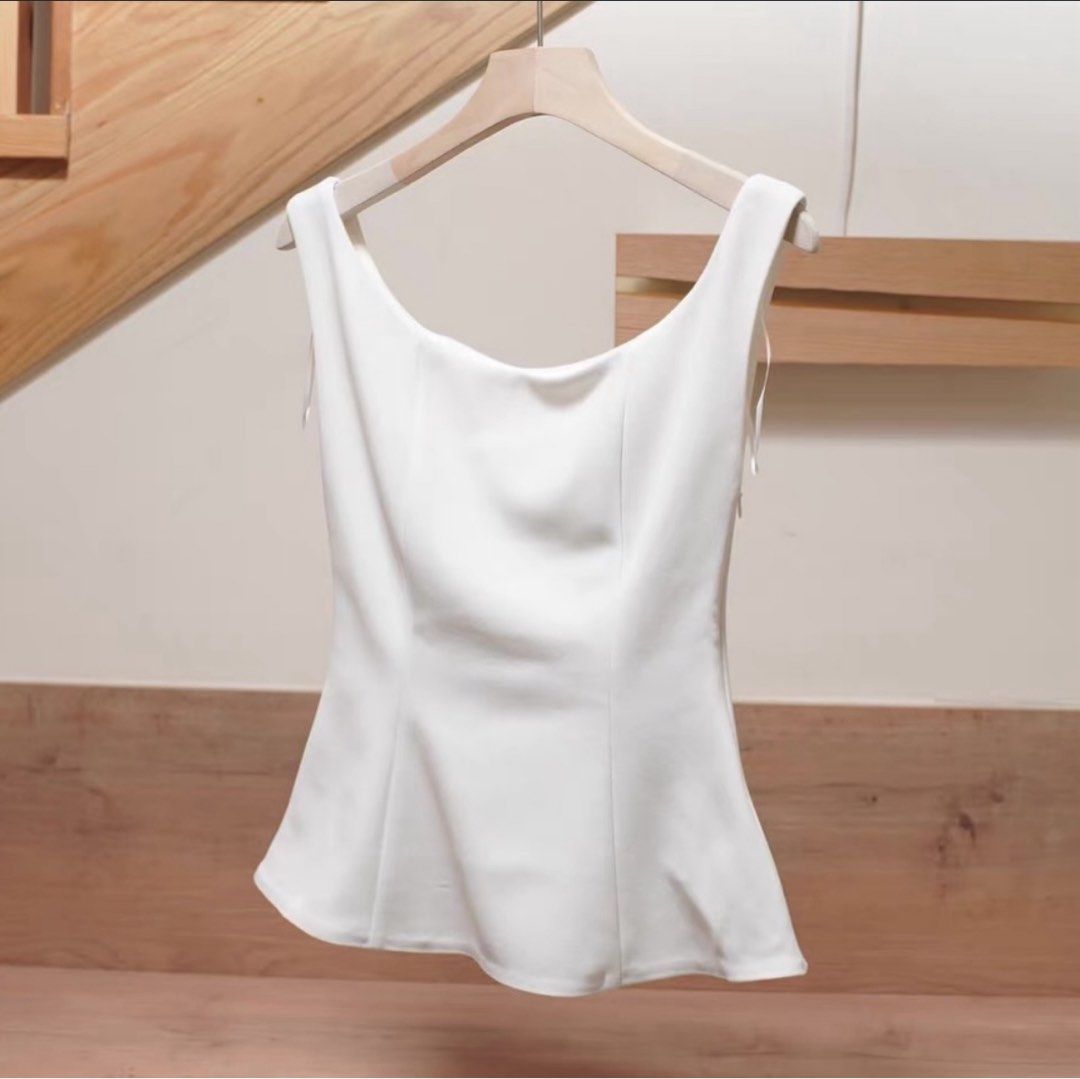Zara White sleeveless top (Category: Sleeveless) located in Cebu City. Submitted by swift.allyn (Listing ID 1464967399, Image 1). Description: - Color: White - Style: Sleeveless with scoop neckline and fitted body with flared hem - Condition: Worn once (valentines date only) excellent shape - Versatility: Minimalist design, easy to match with skirts or pants for work or casual wear.