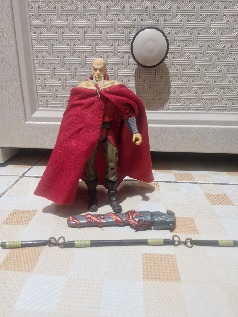 Action Figure with Cape and Accessories (Category: Figurines & Statues) located in Bacolod City. Submitted by racielle (Listing ID 1459381823, Image 1). Description: - Detailed fantasy action figure - Features a striking red cape - Comes with a staff and a weapon - Bald head design - Accessories showcase intricate dragon motifs - Ideal addition for any collector's display.