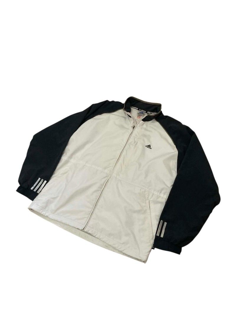 Adidas Track Jacket White Black Three Stripes (Category: Coats, Jackets and Outerwear) located in Trece Martires City. Submitted by djaothriftshop (Listing ID 1459431552, Image 1). Description: -Dimes 24x29 Classic Adidas track jacket - White body with black sleeves - Iconic three stripes on sleeves - Full zip closure - Stand-up collar - Two zip pockets - Drawstring hem - Ideal for sports or casual wear.