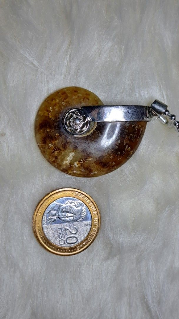 Ammonite Fossil Pendant with Silver Chain (Category: Necklaces) located in Quezon City. Submitted by crystallinehaven (Listing ID 1459352788, Image 2). Description: - Unique ammonite fossil pendant - Natural amber and brown tones - Set in sterling silver - Includes a silver chain - Approximately the size of a 20 Piso coin - A fantastic conversation piece 💥READ FIRST THANKS💥 "My Collections and I'm Letting go and Releasing it" ♦️These are the On