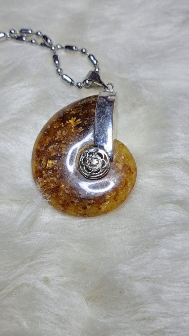 Ammonite Fossil Pendant with Silver Chain (Category: Necklaces) located in Quezon City. Submitted by crystallinehaven (Listing ID 1459352788, Image 1). Description: - Unique ammonite fossil pendant - Natural amber and brown tones - Set in sterling silver - Includes a silver chain - Approximately the size of a 20 Piso coin - A fantastic conversation piece 💥READ FIRST THANKS💥 "My Collections and I'm Letting go and Releasing it" ♦️These are the On