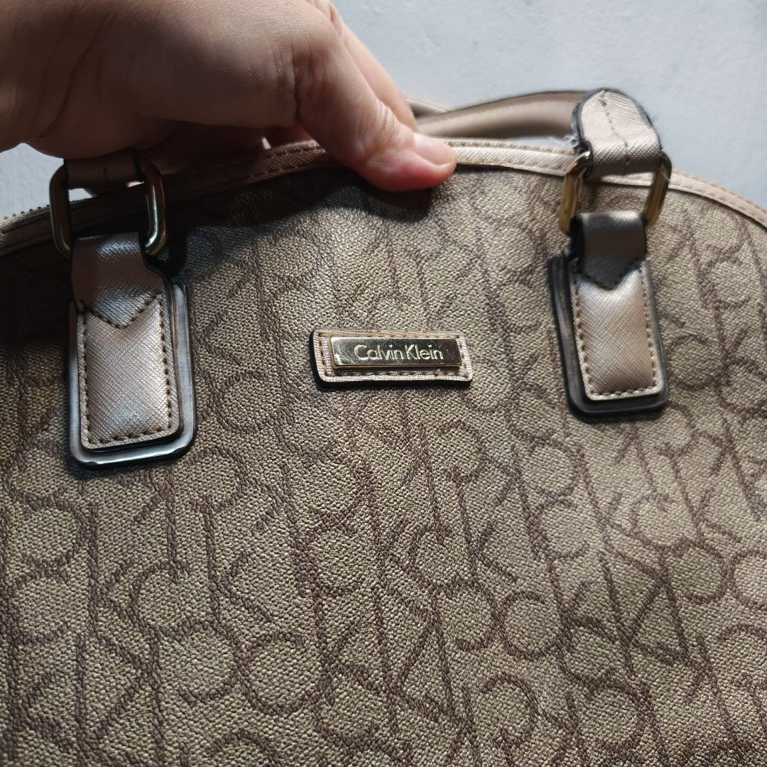 Authentic Calvin Klein Monogram Satchel (Category: Luxury Bags & Wallets) located in Cavite. Submitted by donyachuHandicraft (Listing ID 1459397593, Image 3). Description: Please Read Carefully Price posted 989 Authentic Calvin Klein Monogram Satchel Bag Color: brown and tan champagne gold 2 way Shoulder Cross Body Bag Model JDF76 Well used See issues sa photos Please view all photos before purchasing Pay tru Gcash Ship tru Gogoexpress / Lalamove