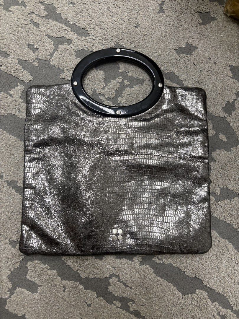 Authentic Kate Spade Metallic Embossed Foldover Clutch Bag (Category: Luxury Bags & Wallets) located in Manila. Submitted by foundhouseph (Listing ID 1459438562, Image 2). Description: - Authentic Metallic Kate Spade clutch - Unique glittery embossed texture all over - Stylish black ring handle - Convenient zip pocket on the back - Interior zip closure - Ideal for evening events and special occasions .