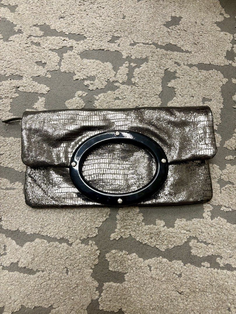 Authentic Kate Spade Metallic Embossed Foldover Clutch Bag (Category: Luxury Bags & Wallets) located in Manila. Submitted by foundhouseph (Listing ID 1459438562, Image 1). Description: - Authentic Metallic Kate Spade clutch - Unique glittery embossed texture all over - Stylish black ring handle - Convenient zip pocket on the back - Interior zip closure - Ideal for evening events and special occasions .