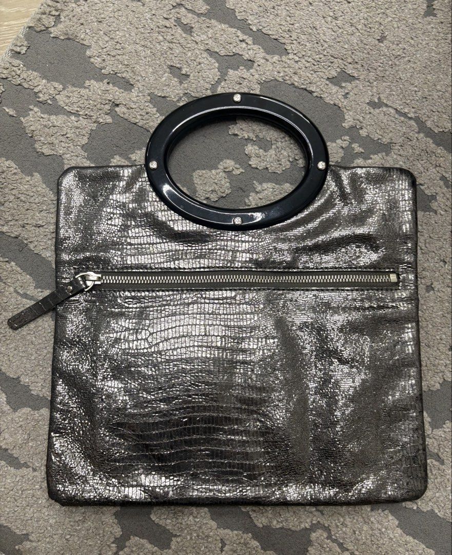 Authentic Kate Spade Metallic Embossed Foldover Clutch Bag (Category: Luxury Bags & Wallets) located in Manila. Submitted by foundhouseph (Listing ID 1459438562, Image 3). Description: - Authentic Metallic Kate Spade clutch - Unique glittery embossed texture all over - Stylish black ring handle - Convenient zip pocket on the back - Interior zip closure - Ideal for evening events and special occasions .