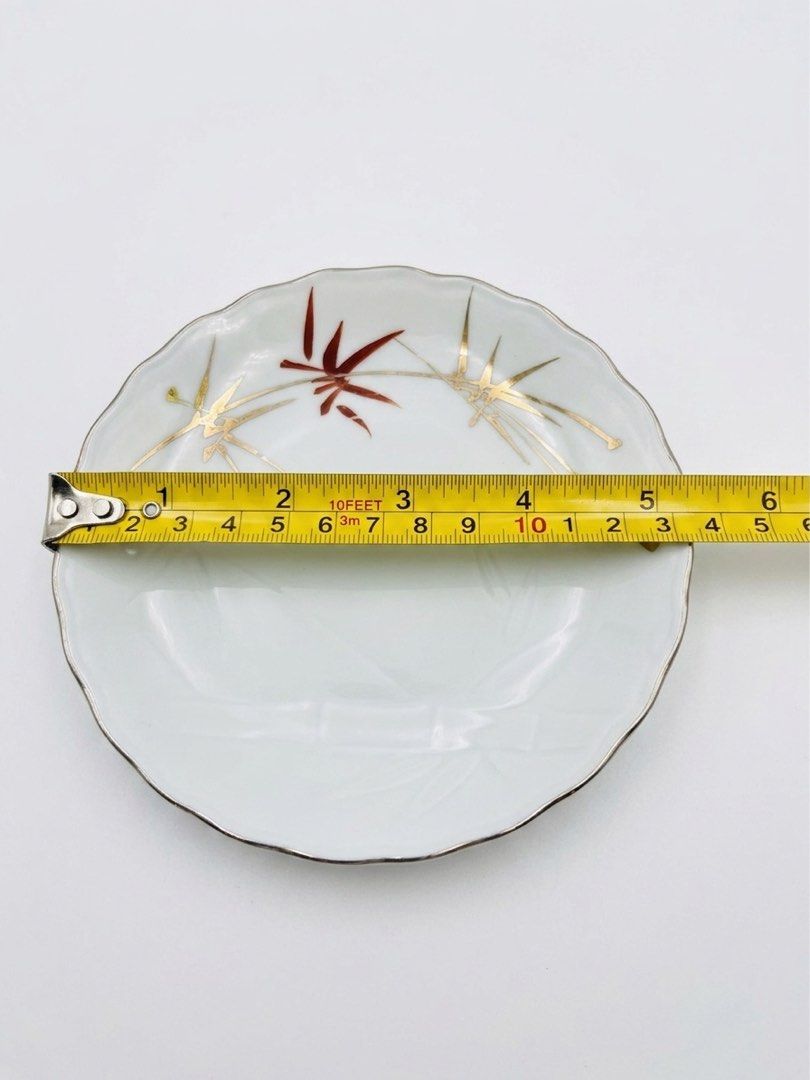 Bamboo small plates (Category: Other Kitchenware & Tableware) located in Manila. Submitted by rlab_japan_thrift (Listing ID 1459398364, Image 3). Description: Vintage Japanese Bamboo Ceramic Saucer / Small Plate Set (Set of 6) 🎋✨ Elegant Japanese porcelain small dish set featuring hand-painted gold and rust-red bamboo leaf accents, subtle embossed bamboo stalk detailing on a light celadon-tinted base, and scalloped edges. Perfect for serving tea