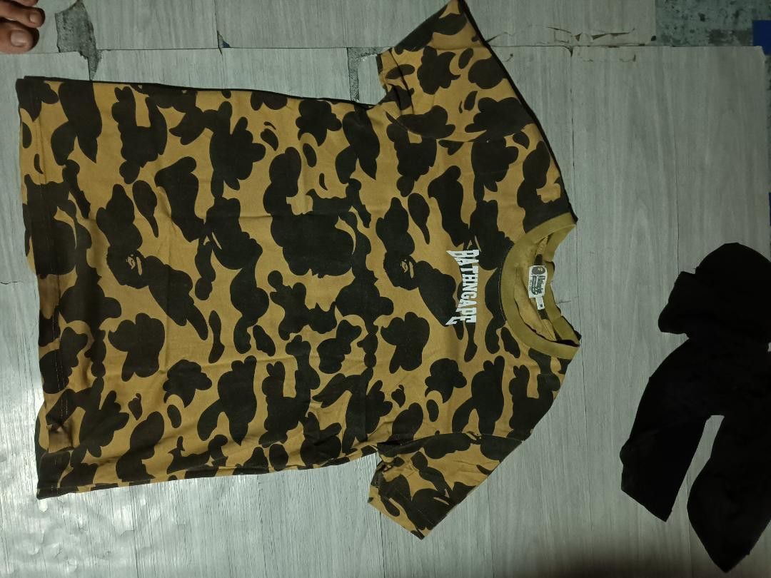 BAPE WGM Busy Works Camo Tee (Category: Tshirts & Polo Shirts ) located in Manila. Submitted by jhonkenagu57088 (Listing ID 1459396046, Image 2). Description: - Authentic BAPE tee - Eye-catching yellow and black camouflage pattern - Features iconic WGM Busy Work graphic on the back - Classic short sleeves and crew neck design - Ideal for everyday casual wear.