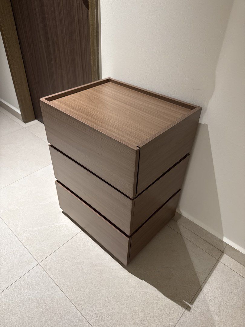 Bedside Table Stackable 3 stacks (Category: Shelves, Cabinets & Racks) located in Singapore. Submitted by adalex9 (Listing ID 1459428238, Image 1). Description: - 3-drawer chest (1 drawer is a lil warped) - 67 x 50 x 40cm - Wood grain finish - Ideal for storage in any room (bedroom, living room, etc.) - Smooth-gliding drawers - Compact size, perfect for smaller spaces - Can be used as a bedside table or for extra storage - Clean interior, well-ma