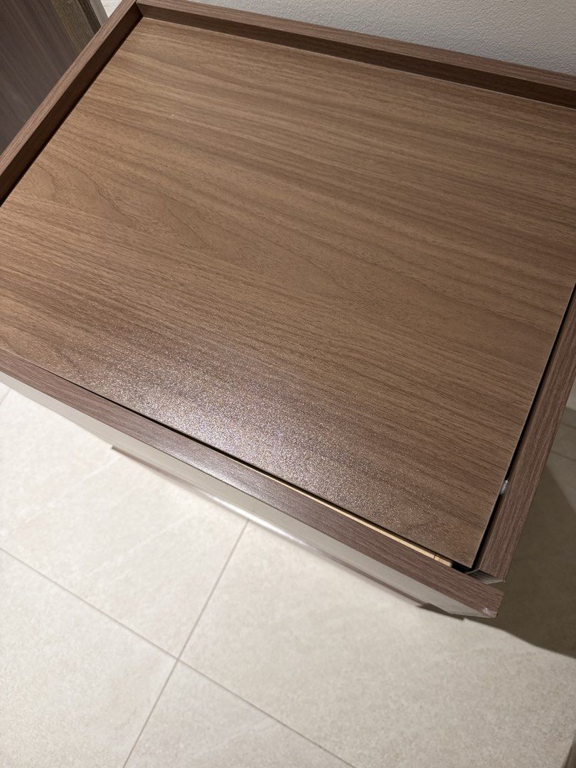 Bedside Table Stackable 3 stacks (Category: Shelves, Cabinets & Racks) located in Singapore. Submitted by adalex9 (Listing ID 1459428238, Image 2). Description: - 3-drawer chest (1 drawer is a lil warped) - 67 x 50 x 40cm - Wood grain finish - Ideal for storage in any room (bedroom, living room, etc.) - Smooth-gliding drawers - Compact size, perfect for smaller spaces - Can be used as a bedside table or for extra storage - Clean interior, well-ma