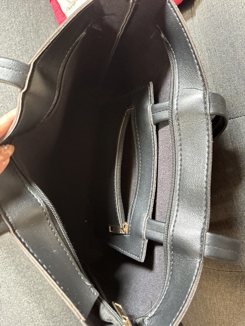 Black Faux Leather Tote Bag (Category: Tote Bags) located in Muntinlupa City. Submitted by urxyy (Listing ID 1459359516, Image 2). Description: - Stylish black tote bag - Made from durable faux leather - Main compartment with secure zip closure - Interior zippered pocket and slip pocket - Sturdy and comfortable handles - Ideal for everyday use - Fits all your daily essentials.