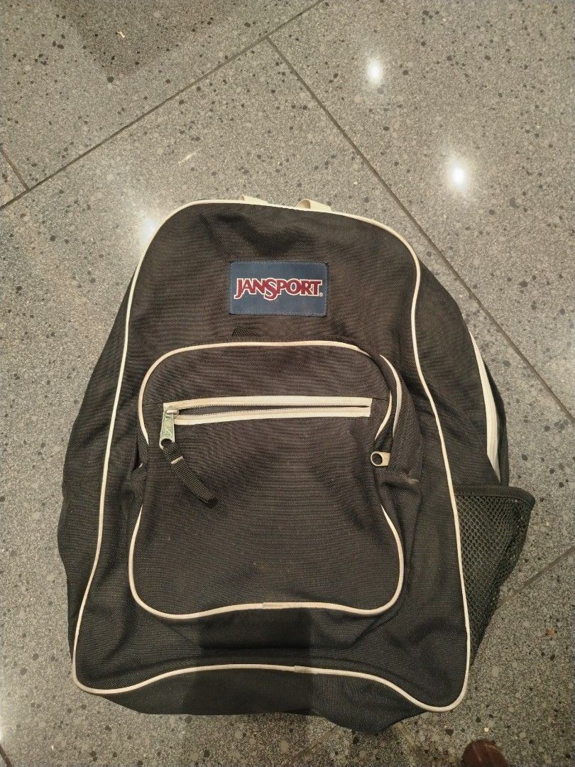 Black Jansport Backpack with White Trim (Category: Backpacks) located in Manila. Submitted by purediamond888 (Listing ID 1459440426, Image 1). Description: - Classic black Jansport backpack - Front zip pocket - Side mesh pocket - Adjustable, padded straps for comfort - Spacious main compartment - Ideal for school or everyday use - Minor signs of wear on straps and interior.