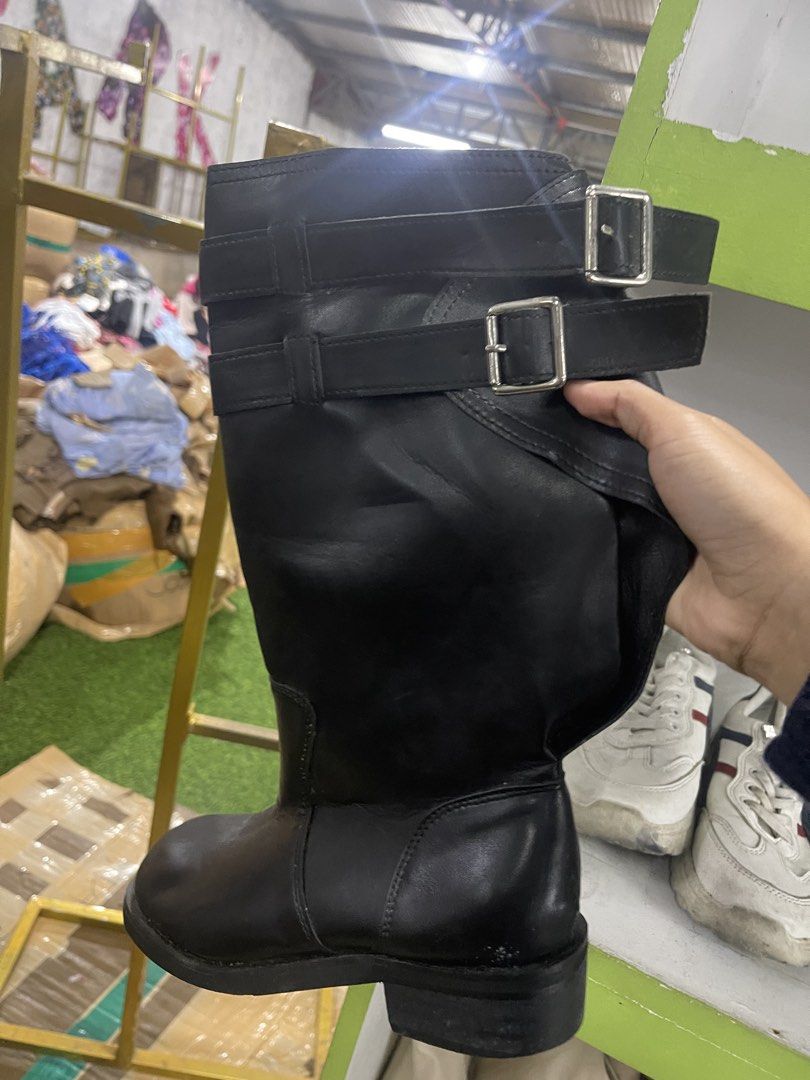 Black Leather Buckle Boots (Category: Boots) located in Caloocan City. Submitted by potatothriftlip (Listing ID 1459386798, Image 1). Description: - Classic black leather biker boots - Knee-high length - Features stylish buckle details - Made from durable leather - Ideal for creating an edgy outfit.