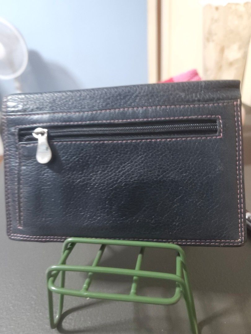 Black Leather Wallet with Eyelet Detail (Category: Wallets & Card holders) located in Manila. Submitted by hausofgadgetatbp (Listing ID 1459429049, Image 3). Description: - Chic black leather wallet - Eye-catching silver eyelets and pink accents - Multiple interior card slots - Convenient zippered coin pocket on the back - Secure snap closure - Ideal everyday size.