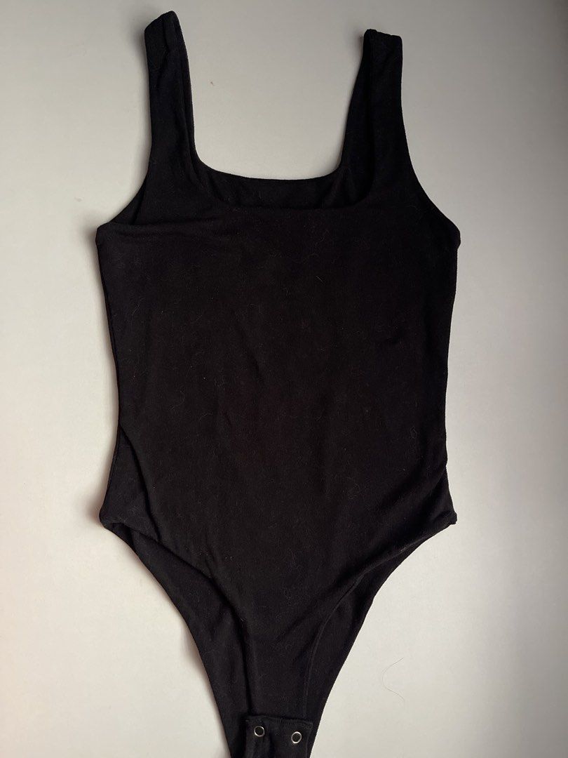 Black Square Neck Sleeveless Bodysuit (Category: Sleeveless) located in Manila. Submitted by _lovemeagain (Listing ID 1459471182, Image 1). Description: - Basic black bodysuit - Square neckline - Sleeveless design - Snap closure at the bottom - Stretchy material for a comfortable fit - Versatile: great for layering or wearing on its own.