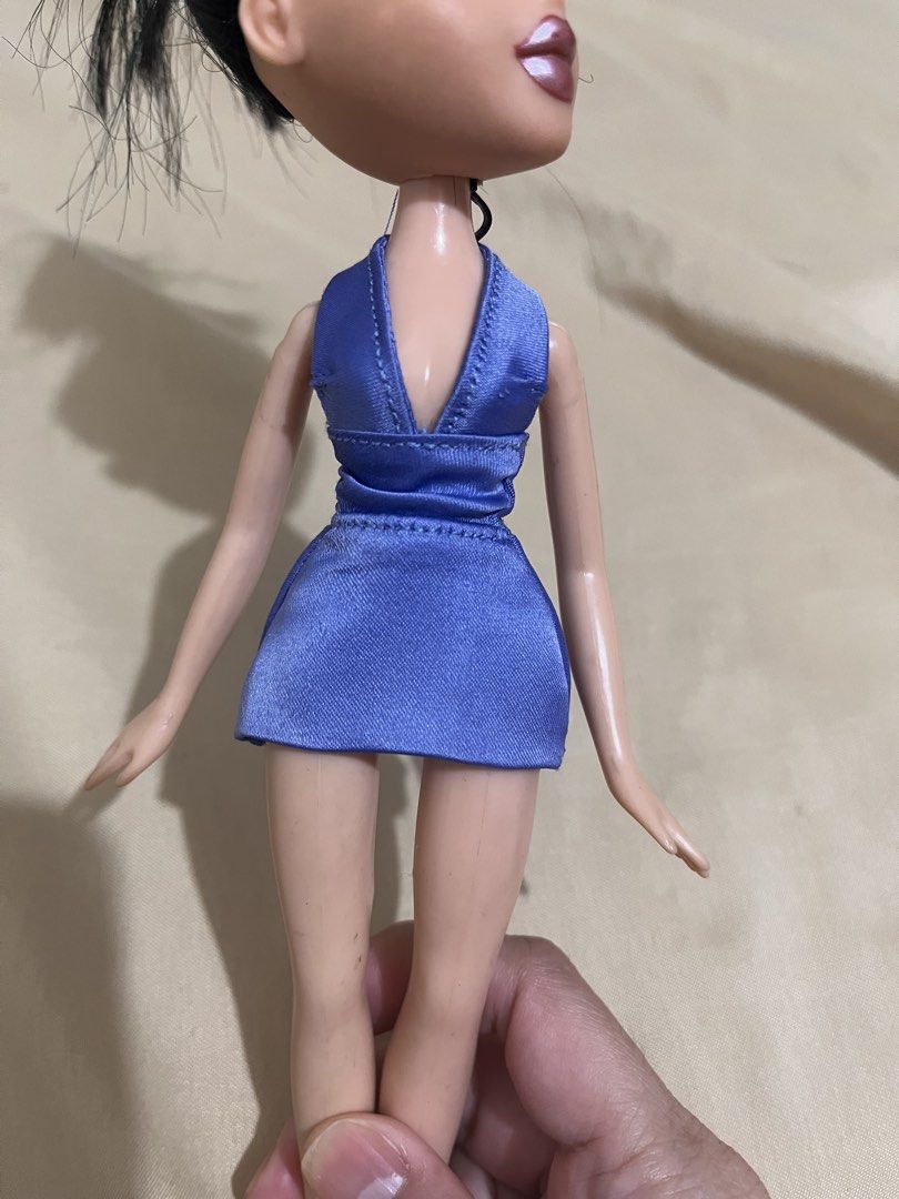 Bratz Doll Blue Halter Dress (Category: Dresses) located in Marikina City. Submitted by zipporahclothing (Listing ID 1459478760, Image 1). Description: - Bratz doll featuring a stylish blue halter dress - Dress details: deep V-neck and cinched waist - Doll has dark hair and iconic Bratz makeup - Note: Minor marks present on the doll's legs - Perfect for Bratz collectors or for playtime fun!.