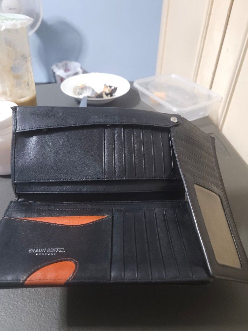 Braun Büffel Leather Wallet (Category: Luxury Bags & Wallets) located in Manila. Submitted by hausofgadgetatbp (Listing ID 1459417194, Image 2). Description: - Genuine Braun Büffel black leather wallet - Ample card slots for all your essentials - Clear window for easy ID or photo display - Stylish orange accent on an inner pocket - Compact and practical size for everyday carry.