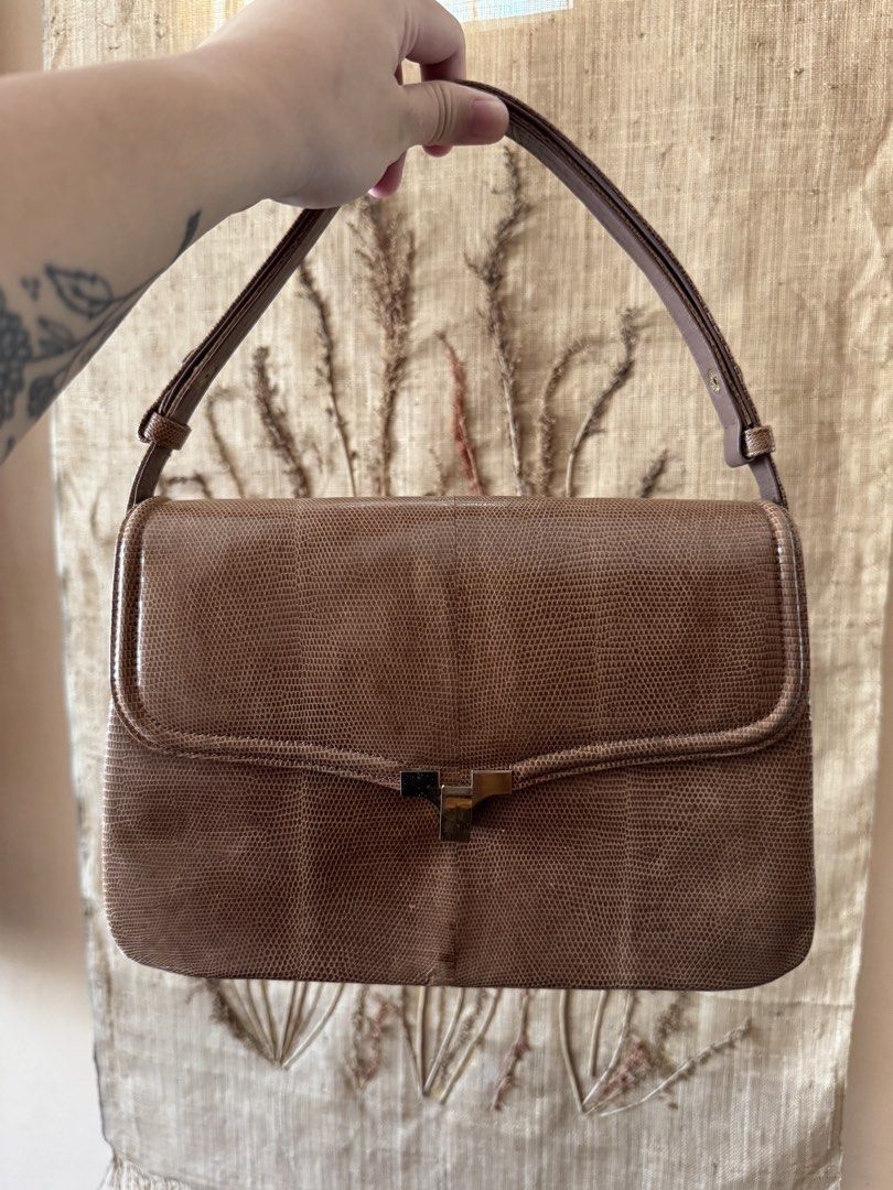Brown Lizard-Embossed Shoulder Bag with Gold Clasp (Category: Luxury Bags & Wallets) located in Bacoor. Submitted by nicafindssince2022 (Listing ID 1459406710, Image 1). Description: - Brown shoulder bag with lizard-embossed texture - Classic flap closure with gold-tone metal clasp - Adjustable strap for comfortable wear - Structured shape with a vintage feel - Perfect for adding a sophisticated touch to any outfit - Approximate measurements: 10 