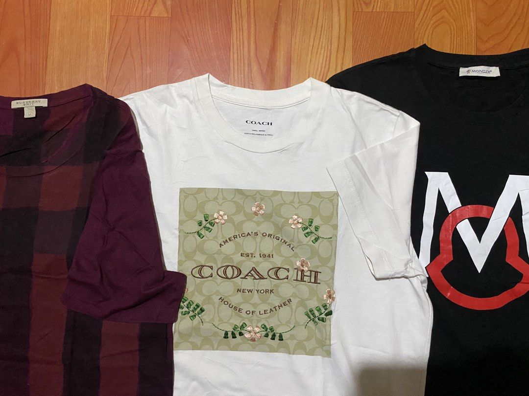 Burberry, Coach, Moncler T-Shirts Bundle (Category: Luxury Apparel) located in Cebu City. Submitted by monflor (Listing ID 1459432747, Image 3). Description: - Bundle of 3 designer t-shirts - Includes: Burgundy Burberry plaid tee, White Coach graphic tee, Black Moncler logo tee - All short-sleeved - Ideal for casual wear Size small to medium Good condition No issues Price each 745.