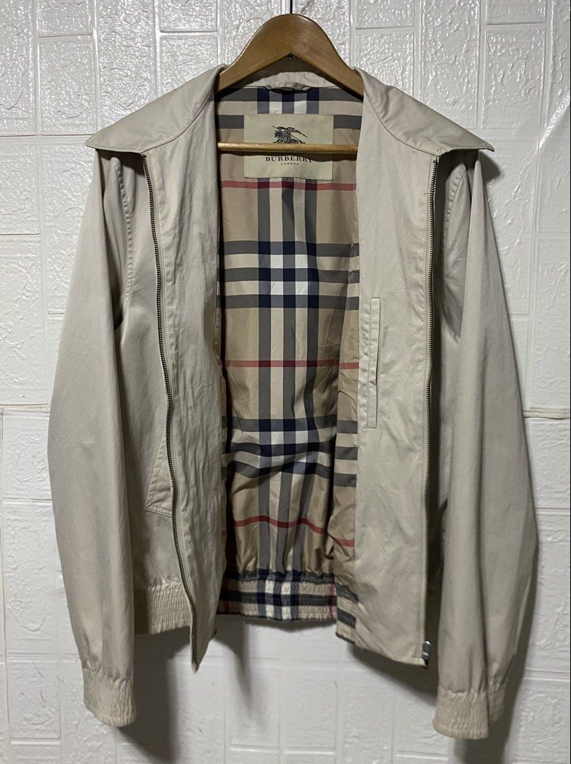 Burberry Harrington Jacket Beige Nova Check Lining (Category: Coats, Jackets and Outerwear) located in Malaybalay. Submitted by madas1992 (Listing ID 1459385788, Image 2). Description: - Classic Burberry jacket in beige. - Iconic Nova Check lining inside. - Zip-up front closure. - Elasticated cuffs and hem for a snug fit. - Features embroidered Burberry Equestrian Knight logo on the chest. - Ideal for versatile layering..