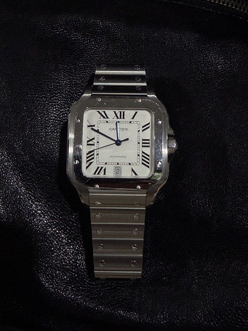 Cartier Santos large (Category: Luxury Watches) located in Mandaluyong City. Submitted by gusteng (Listing ID 1459443641, Image 1). Description: 20 links Box Case Width: 39.8 mmThickness: 9.38 mmLug-to-Lug: Approx. 47.5 mmMaterial: Stainless steel (with variations available in two-tone or ADLC/carbon bezel finishes)Crown: 7-sided crown set with a faceted synthetic spinelWater Resistance: Up to 10 bar (100 meters / 328 feet)Movement and FeaturesCa