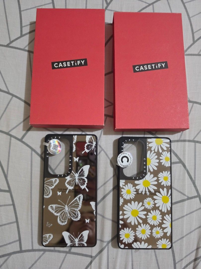 CASETiFY Phone Cases - Daisy & Butterfly Designs (Category: Cases & Sleeves) located in Cebu City. Submitted by out_of_the_box (Listing ID 1459423399, Image 1). Description: - Two CASETiFY phone cases for sale. - Case 1: White daisy print mirror - Case 2: White butterfly mirror - Both cases come with their original CASETiFY boxes. - Offers excellent phone protection and stylish aesthetics. Selling for 2500 each free shipping via JRS from Cebu.