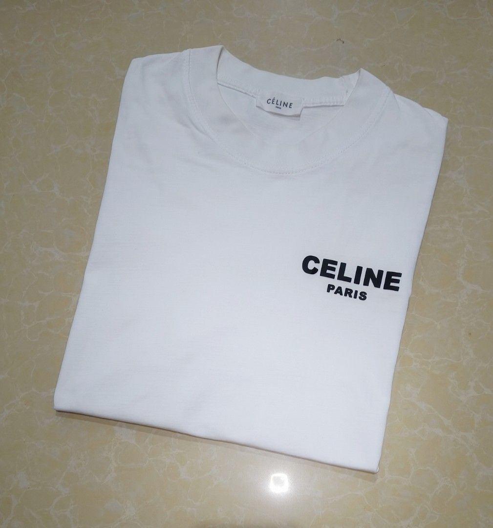 Celine Paris White T-Shirt (Category: Tshirts & Polo Shirts ) located in Manila. Submitted by purefire-477a (Listing ID 1459352455, Image 2). Description: - Authentic Celine Paris White T-shirt - Features the signature Celine logo on both the front and back - Size: 22 inches width x 29 inches length - Condition: Excellent, rated 9.5/10 for color vibrancy - A perfect staple piece for effortless style and comfort.