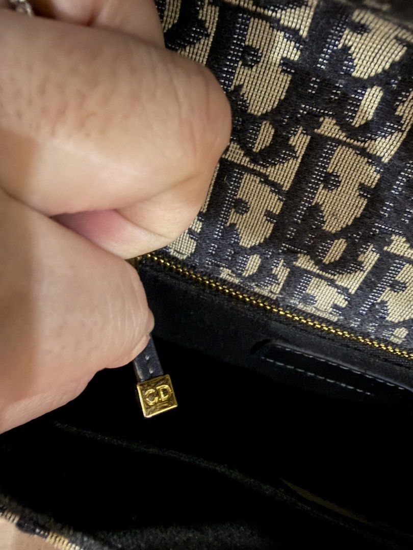 Christian Dior Shoulder Sling Bag (Category: Luxury Bags & Wallets) located in Caloocan City. Submitted by princessthriftbags (Listing ID 1459299126, Image 2). Description: - Dior Trotter shoulder or can be sling bag - coded and this is korea ukay bag preloved so pls manage your expectation - Classic navy blue and beige monogram canvas - Black leather trim - Signature gold CD buckle detail - Adjustable shoulder strap - Interior zip pocket - Ideal