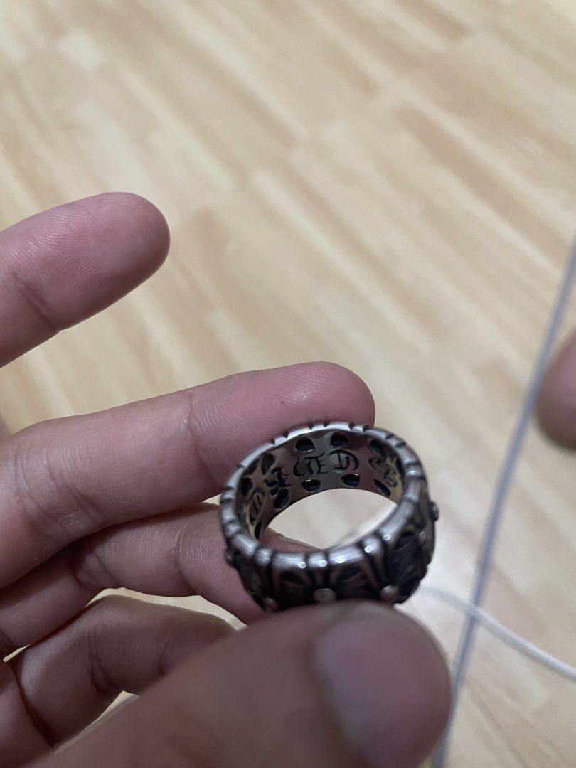 Chrome Hearts Style Silver Ring (Category: Jewelry) located in Quezon City. Submitted by hanzpaolo_123. (Listing ID 1459403193, Image 3). Description: - Unique silver ring with a repeating cross motif. - Intricate detailing and a substantial, quality feel. - Features lettering inside the band (possible brand name). - A true statement piece that adds an edgy vibe to any style. - Versatile design complements various looks..